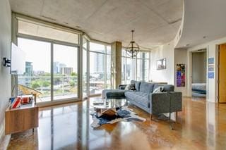 living room with a wall of windows and a chandelier