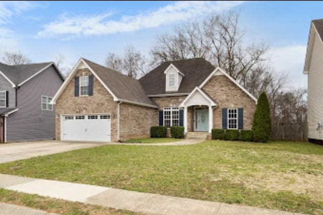 view of front facade featuring a garage, concrete driveway, and a front yard