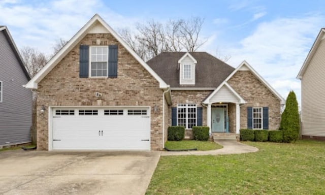 traditional-style home with a garage, driveway, a front lawn, and brick siding