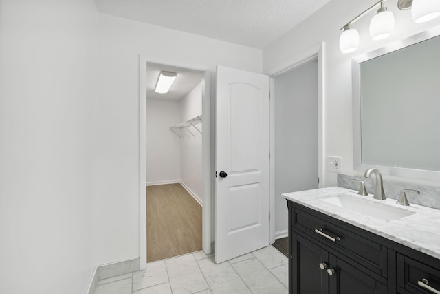 6992 Mill Creek Rd, Lyles, TN 37098 - bathroom featuring a walk in closet, marble finish floor, vanity, and baseboards