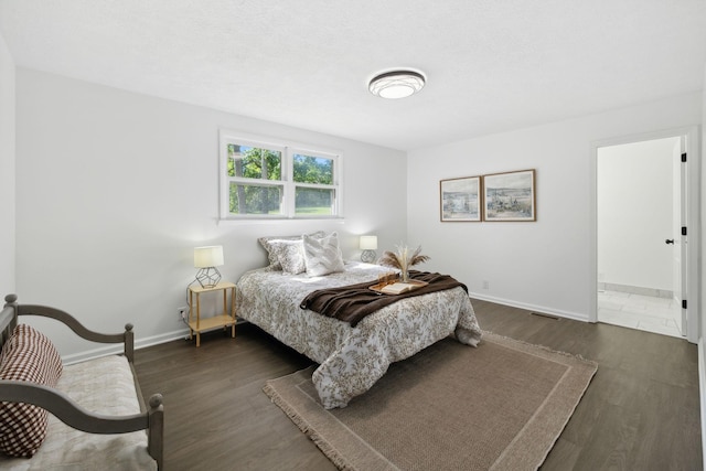 6992 Mill Creek Rd, Lyles, TN 37098 - bedroom with dark wood-type flooring, visible vents, and baseboards