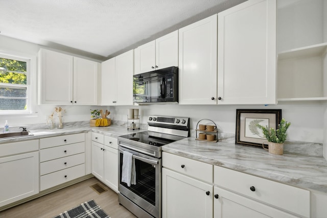 6992 Mill Creek Rd, Lyles, TN 37098 - kitchen featuring black microwave, white cabinets, open shelves, and stainless steel electric stove