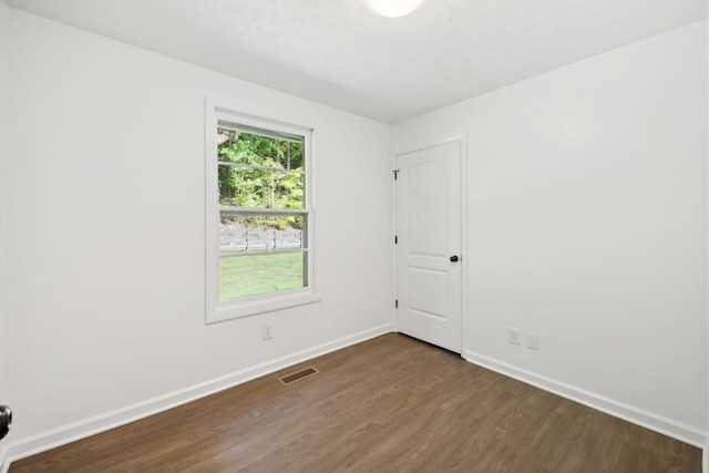 6992 Mill Creek Rd, Lyles, TN 37098 - empty room with dark wood-style floors, visible vents, and baseboards