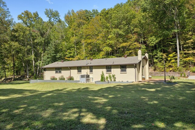 6992 Mill Creek Rd, Lyles, TN 37098 - rear view of property featuring a chimney, cooling unit, and a yard