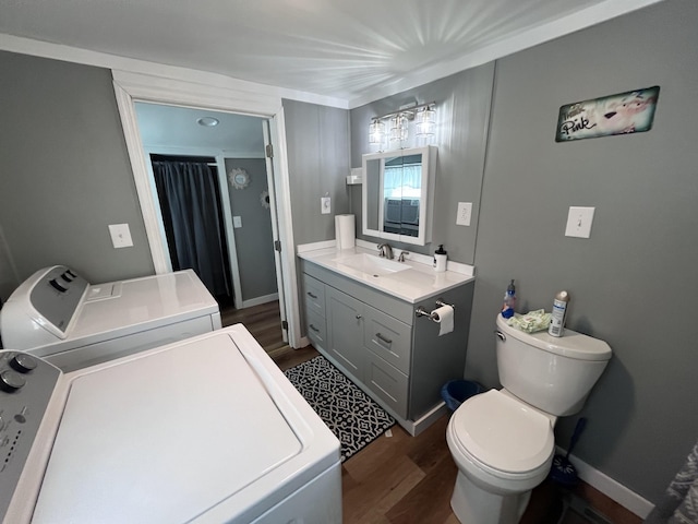 6992 Mill Creek Rd, Lyles, TN 37098 - full bath featuring toilet, wood finished floors, vanity, baseboards, and washer and clothes dryer