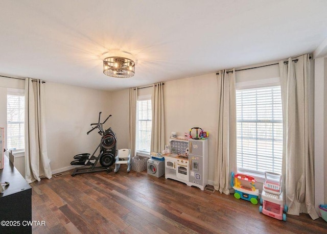 exercise room with dark hardwood / wood-style floors