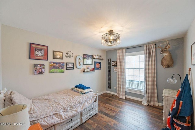 bedroom with dark wood-type flooring