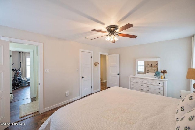 bedroom with multiple windows, dark wood-type flooring, and ceiling fan