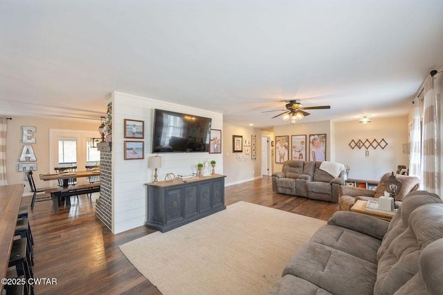 living room featuring dark hardwood / wood-style floors and ceiling fan