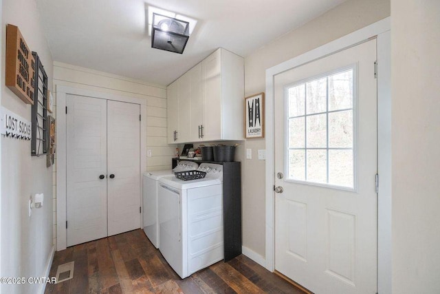 washroom featuring dark wood-type flooring, cabinets, and separate washer and dryer