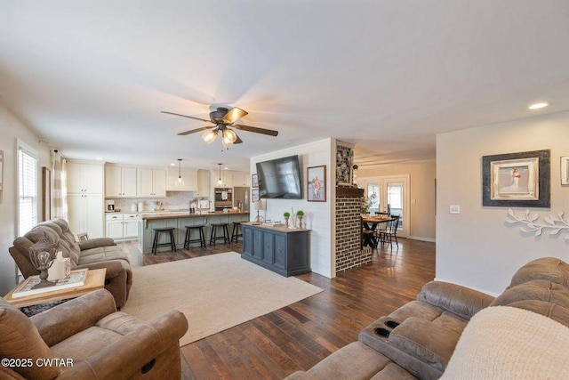 living room with dark hardwood / wood-style floors and ceiling fan