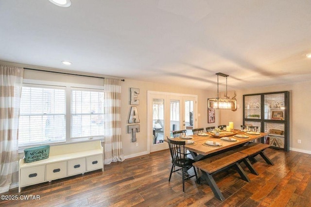 dining space with dark wood-type flooring and french doors