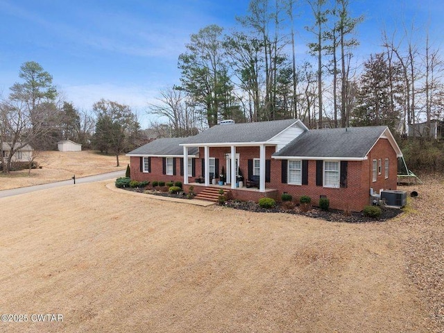 ranch-style house featuring central AC and a porch