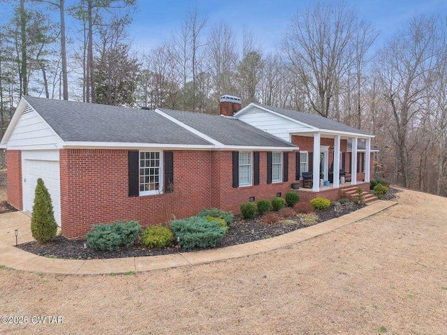 view of property exterior featuring a garage and covered porch