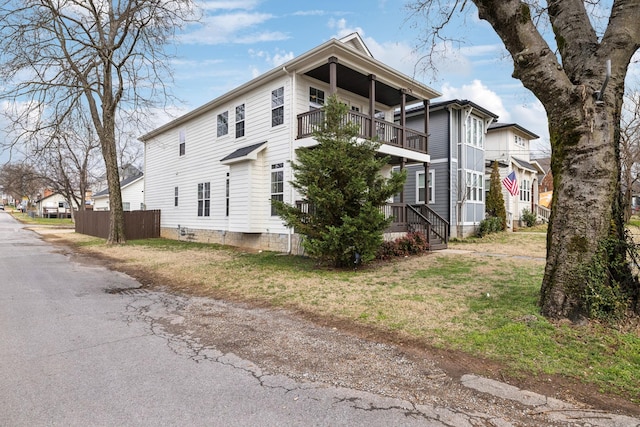 exterior space with a balcony and a yard