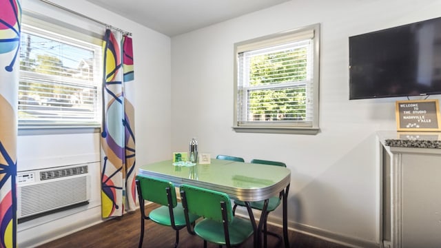 dining area featuring cooling unit and dark hardwood / wood-style flooring