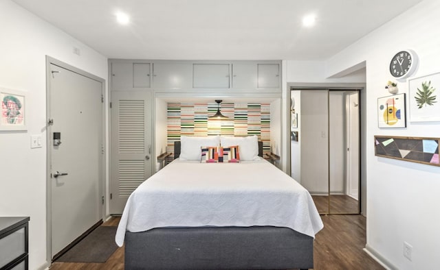 bedroom with dark hardwood / wood-style flooring