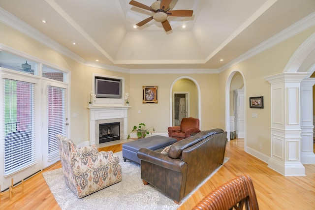 1416 Station Four Ln, Old Hickory, TN 37138 - living room featuring decorative columns, crown molding, a raised ceiling, ceiling fan, and light hardwood / wood-style floors