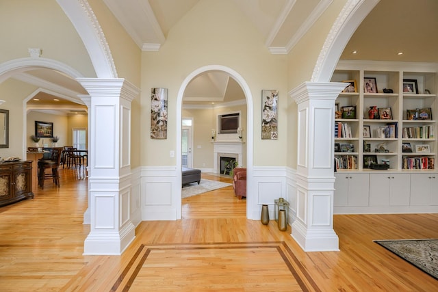 1416 Station Four Ln, Old Hickory, TN 37138 - hallway with crown molding, built in features, decorative columns, high vaulted ceiling, and light hardwood / wood-style floors