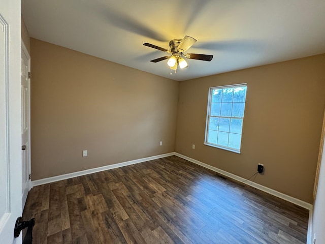 empty room with dark wood-type flooring and ceiling fan