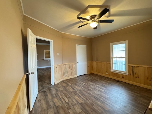 unfurnished bedroom with crown molding, ceiling fan, and dark hardwood / wood-style floors