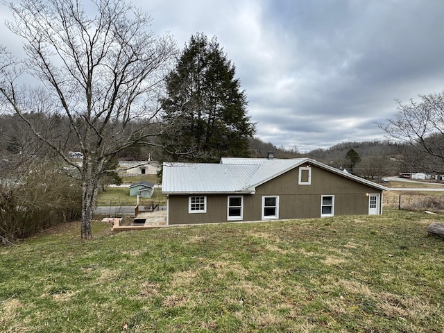 back of property with a lawn