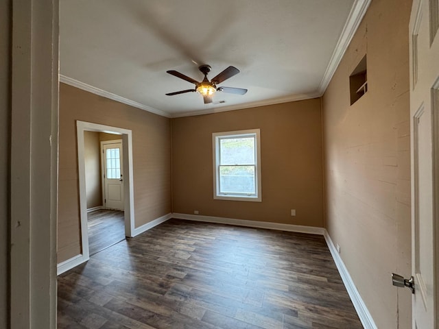 spare room featuring ornamental molding, a wealth of natural light, ceiling fan, and dark hardwood / wood-style flooring