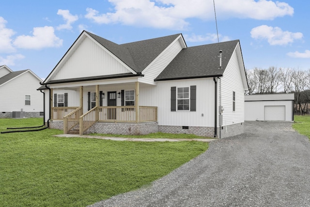 view of front of property featuring a garage, an outdoor structure, a front lawn, and a porch