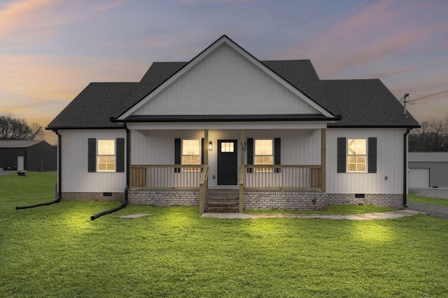 view of front of property featuring covered porch and a lawn