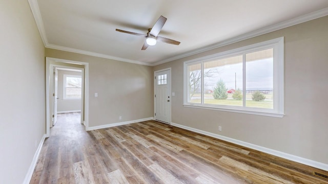 unfurnished room with crown molding, light hardwood / wood-style floors, and ceiling fan