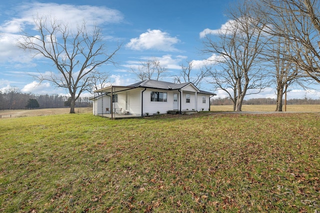 view of front of home with a rural view and a front yard