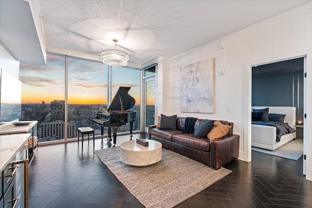 living room featuring a notable chandelier and dark parquet floors