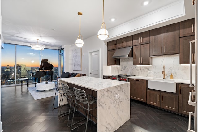 kitchen featuring sink, a kitchen island, dark parquet floors, pendant lighting, and backsplash