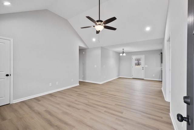 unfurnished living room with ceiling fan, high vaulted ceiling, and light hardwood / wood-style flooring