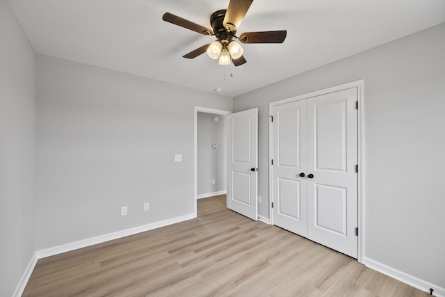 unfurnished bedroom featuring a closet, ceiling fan, and light hardwood / wood-style flooring