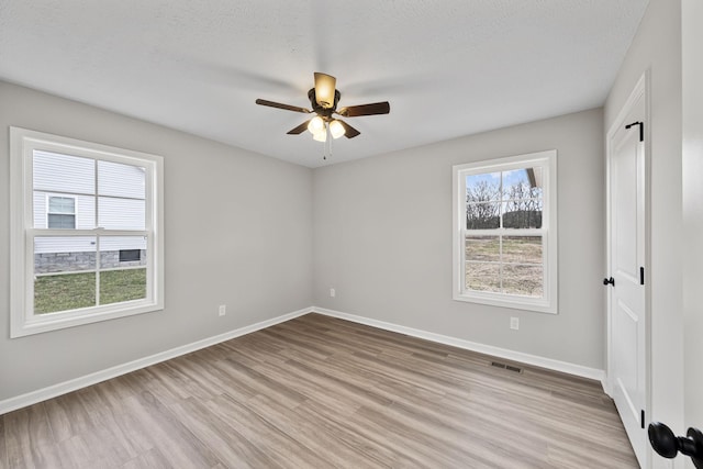 unfurnished bedroom with ceiling fan, light hardwood / wood-style floors, and a textured ceiling