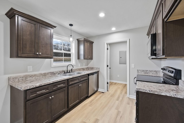 kitchen with appliances with stainless steel finishes, decorative light fixtures, sink, light hardwood / wood-style floors, and dark brown cabinets