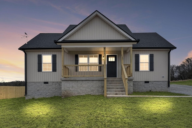 view of front facade with a lawn and a porch