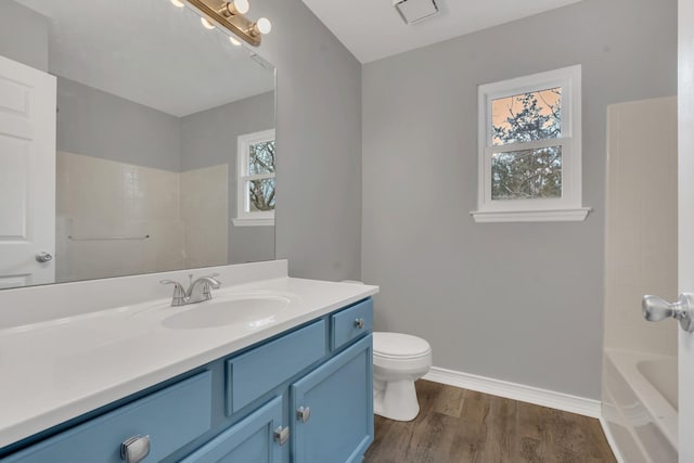 bathroom featuring vanity, hardwood / wood-style floors, and toilet