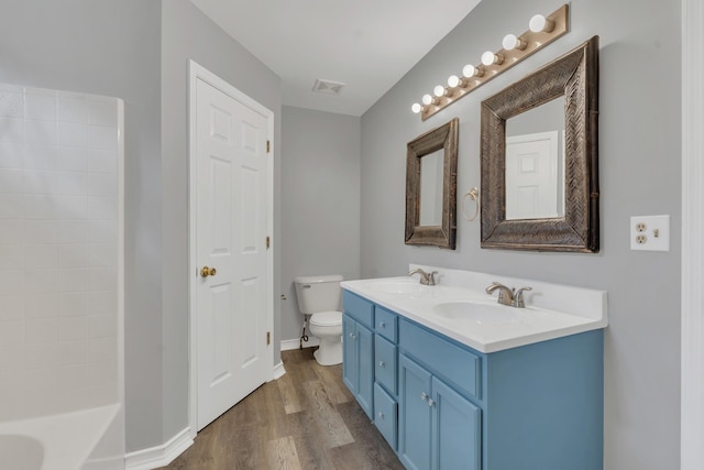 full bathroom featuring shower / tub combination, wood-type flooring, vanity, and toilet