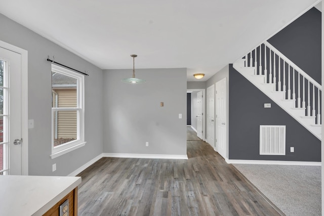 unfurnished dining area featuring dark hardwood / wood-style flooring