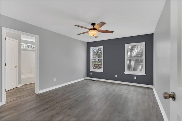 unfurnished room featuring dark hardwood / wood-style floors and ceiling fan