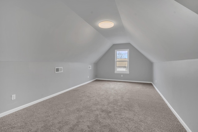 bonus room featuring lofted ceiling and carpet
