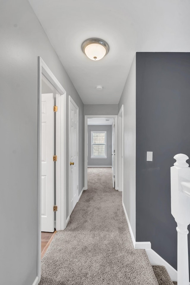 hallway featuring light carpet