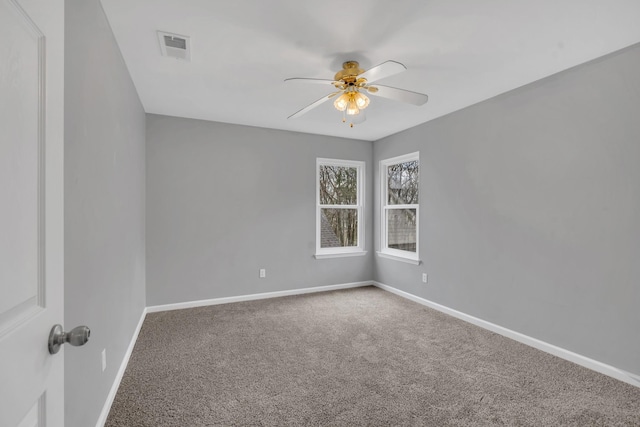 carpeted spare room featuring ceiling fan