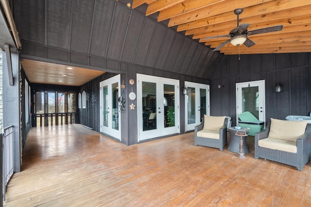 sunroom / solarium with vaulted ceiling, ceiling fan, and french doors