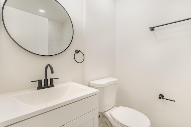 bathroom featuring toilet and vanity