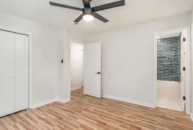 unfurnished bedroom featuring visible vents, light wood-style floors, a ceiling fan, ensuite bath, and baseboards