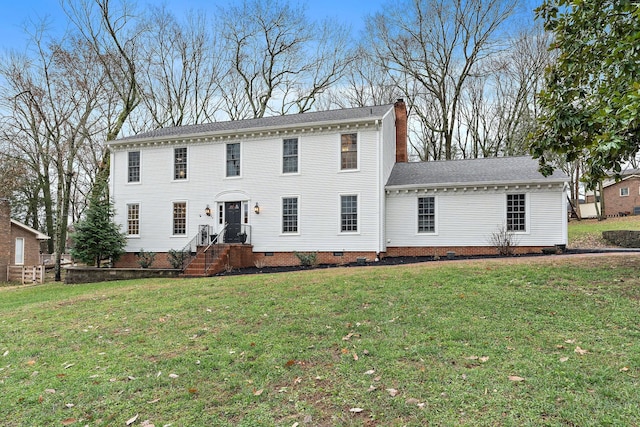 colonial-style house with a front yard