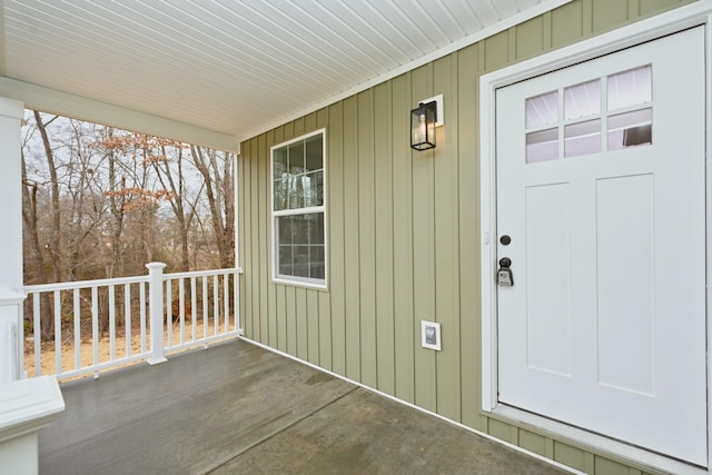 view of exterior entry with a porch